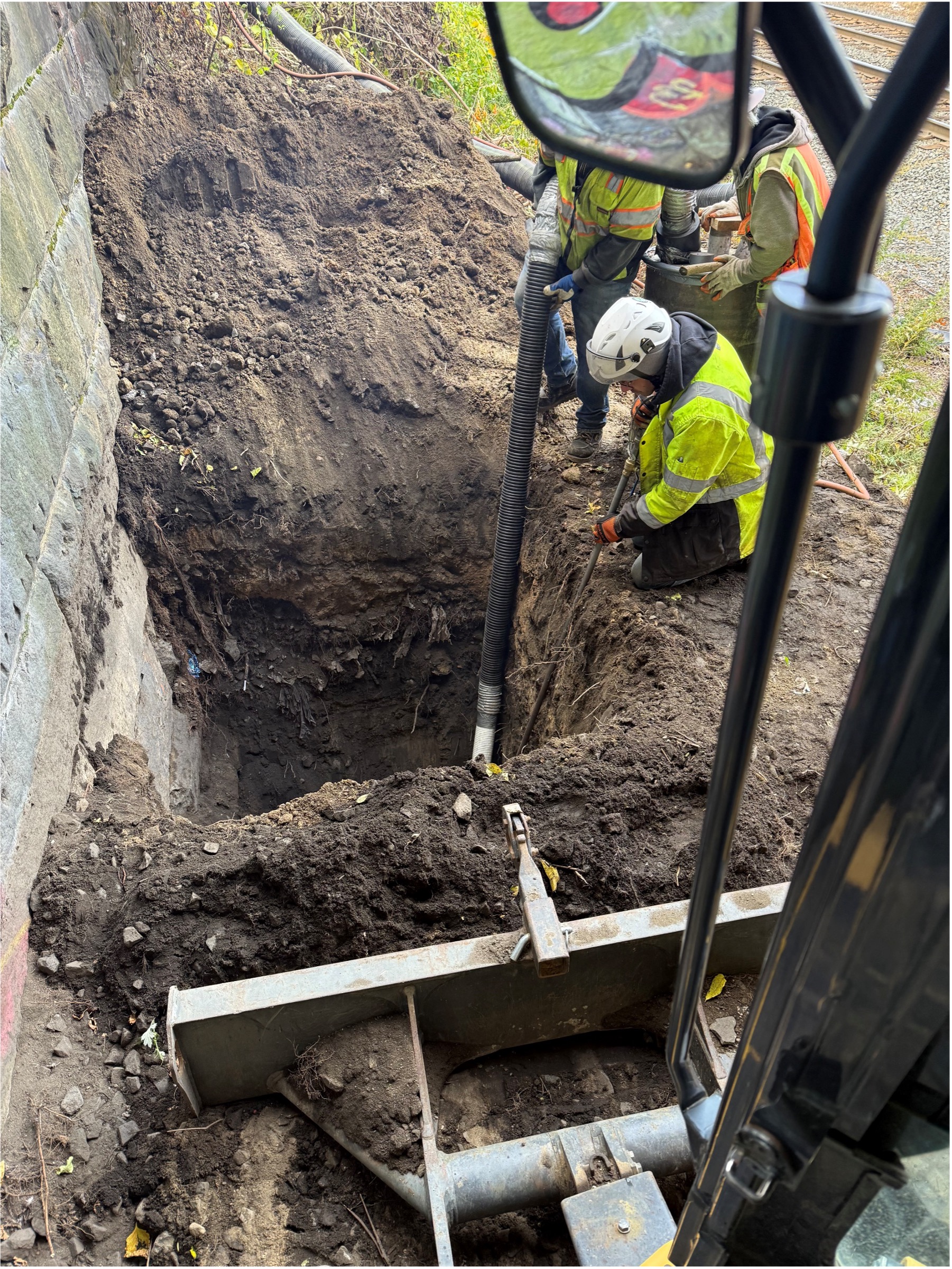 Utility Test Pitting on Sewer Under Bridge Against Bridge Abutment - Armory Street Over CSX Railroad